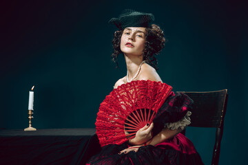 Passion. Young woman as Anna Karenina isolated on dark blue background. Retro style, comparison of...