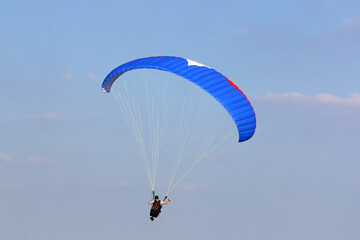 Paraglider flying wing in a blue sky	