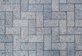 road paved with sidewalk tiles. texture of light gray bricks.