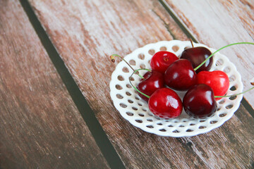 Fototapeta na wymiar natural red cherry fruit in a decorative plate