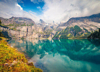 Attractive summer view of unique lake - Oeschinen (Oeschinensee), UNESCO World Heritage Site....