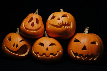 orange pumpkins with carved faces for Halloween celebration. Jack's lantern