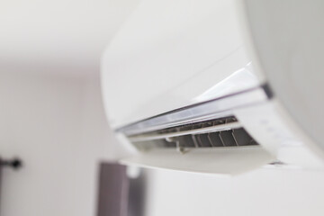 Air conditioner on white wall room interior background