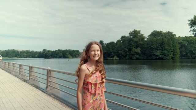 Beautiful slender girl with long hair. Hoverboard riding in the park. Rest on a day off in the park outside.