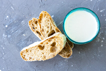 Bread and milk in blue glass. top view