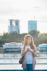 Young woman using phone outside stock photo