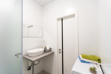 Fototapeta na wymiar Modern twin bathroom with sinks, toilet and shower.