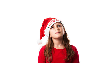 small child wearing santa hat, looking up