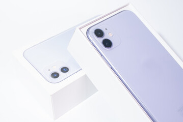 Purple smartphone with two cameras on a white background