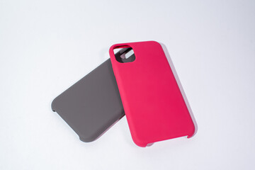 Cases for smartphones in different colors on a white background