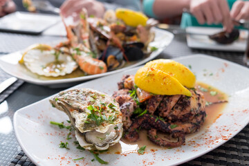 Delicious dish from traditonal cuisine of Malta island - freshly caught octopus grilled with garlic and olive oil and served with wine sauce
