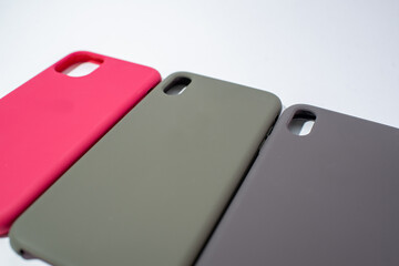 Cases for smartphones in different colors on a white background