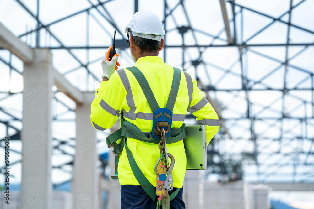 Poster engineer using radio communication on building site,engineer use walkie talkie for work.