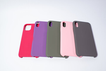 Cases for smartphones in different colors on a white background