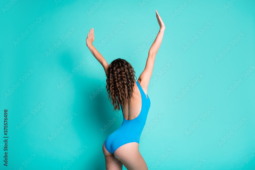 Wall mural back rear view photo of slim energetic active young lady arms air curly hairdo alluring figure dance