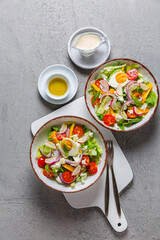 Healthy mixed salad with arugula, egg, onion, feta cheese and radish