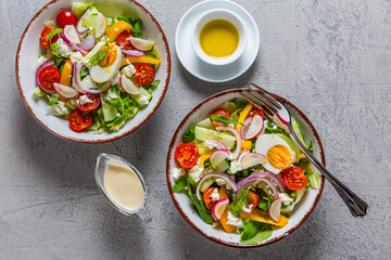 Healthy mixed salad with arugula, egg, onion, feta cheese and radish