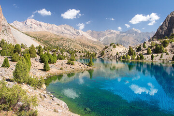 Fototapeta na wymiar Tajikistan. Mountain landscape. Rocky path. Sunny day in Alaudin lake.