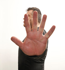 Oh no, dont bother me about this question. Displeased asian man makes refusal gesture, keeps hands...