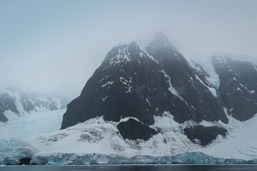 Snow covered mountains and glacier at Paradise Harbour, Antarctica