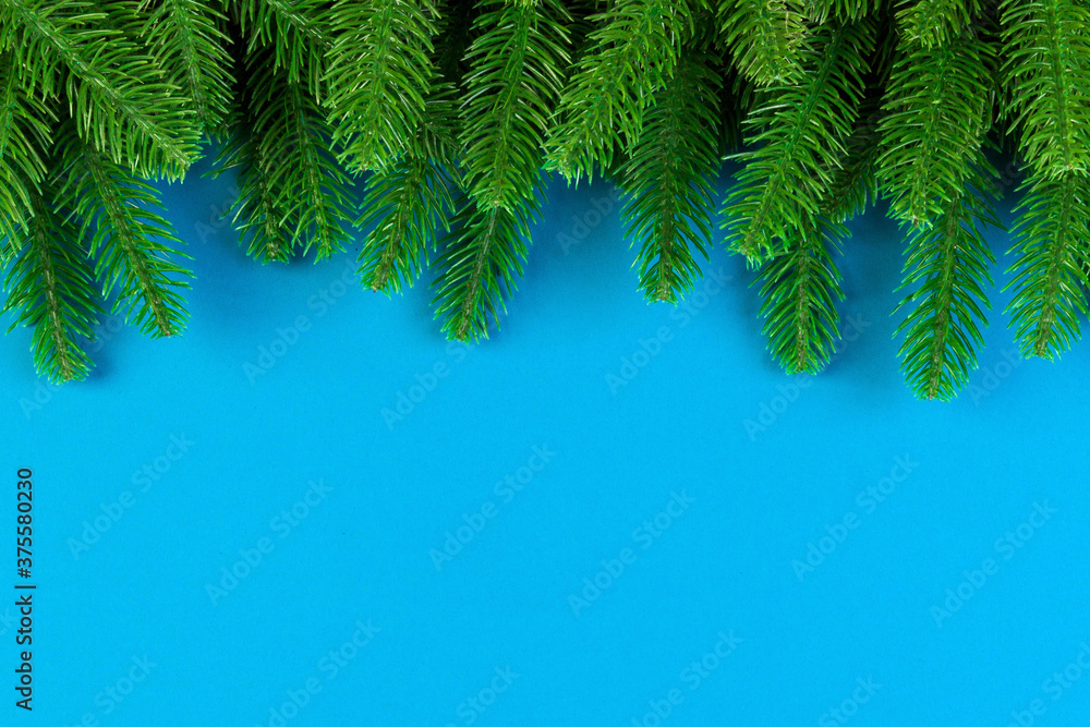 Wall mural top view of colorful festive background made of fir tree branch. christmas holiday concept with copy