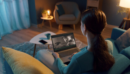 Woman resting on the sofa and connecting with her laptop