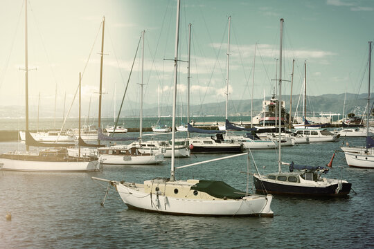 Retro style photo of sailing boats lined up at a marina in central Wellington, New Zealand. Selective focus. Toned image