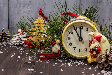 Fototapeta na wymiar Five minutes to midnight. New Year concept. Alarm clock, pine branch, Christmas decorations