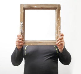 no head in  old wooden window with peeling paint.  without head.