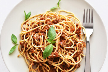 Spaghetti Bolognese with minced beef, onion, chopped tomato, garlic, olive oil, stock cube, tomato puree and Italian herb. Traditional Italian food.