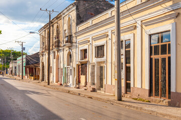 Fototapeta na wymiar Cienfuegos, Cuba-October 13, 2016. Typical town street with colonial-era buildings on October 13, 2016 in historical Cienfuegos, south coast town of Cuba.
