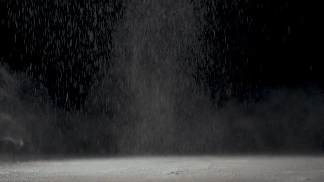 The tennis ball hits the surface and creates clouds of dust.