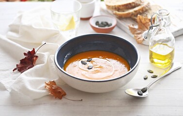 Pumpkin soup with pumpkin seeds.  Selective focus