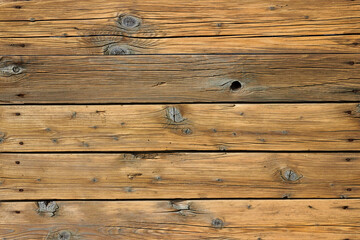 Naklejka premium Wooden floor made of old boards with knots and cracks with rusty nails