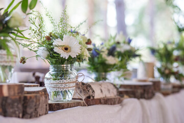 
Rustic decor on a wedding table using natural objects and floristry.