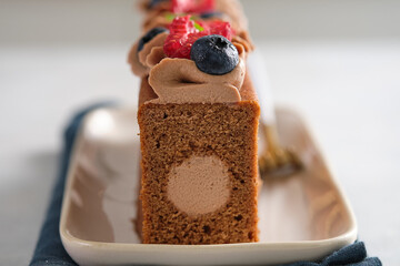 Chocolate cake with chocolate cream decoration and berries. Gourmet cake.