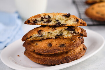 American chocolate chip cookies with chocolate on light marble background. Delicious dessert, close up