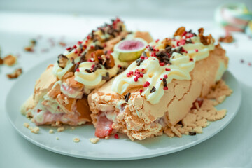 Two servings of meringue roll on a plate