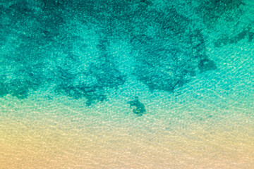 Fototapeta na wymiar Drone shot of clear water and sea bottom - space for text