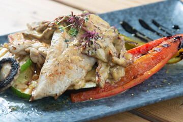 chicken with vegetables on a wooden background