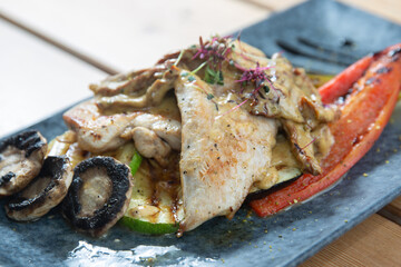 chicken with vegetables on a wooden background