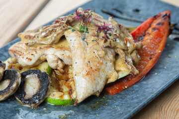 chicken with vegetables on a wooden background