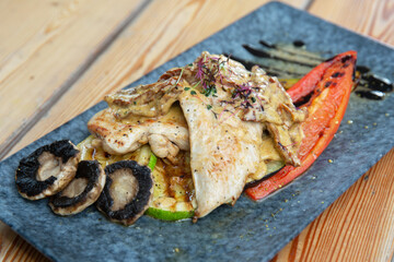 chicken with vegetables on a wooden background