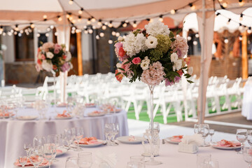 Tables for guests decorated at the banquet