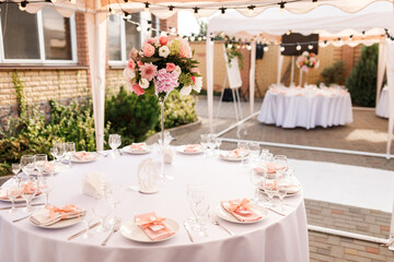 Tables for guests decorated at the banquet