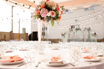 Tables for guests decorated at the banquet