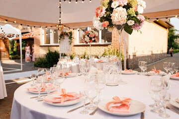 Tables for guests decorated at the banquet