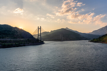 Obraz premium Sunset at the Barrios de Luna reservoir with views of the cable-stayed bridge, Leon (Spain)