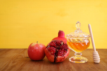 rosh hashanah (jewesh holiday) concept - honey, pomegranate and apple holiday traditional symbols