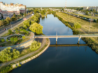 Fototapeta na wymiar Aerial drone view. Walking paths near the lake in the city park of Kiev.